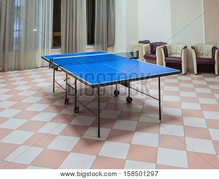 Old Style Photo. Ping-pong tennis table with Paddles on the floor