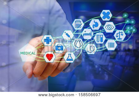 Asian young man pressing medical icon on virtual screen. Healthcare concept.