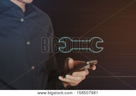 Young Business Man Using Smartphone with Wrench Icon on Light Motion Background and Lens Flare - Digital 3d Effect Style Color