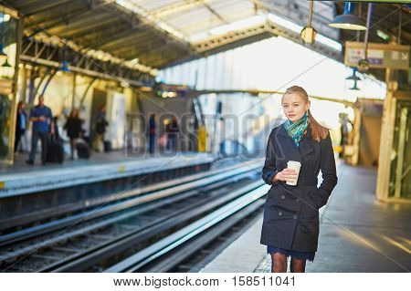 Beautiful Young Woman Waiting For A Train In Parisian Underground