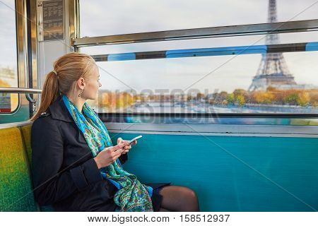 Beautiful Young Woman Travelling In A Train Of Parisian Underground And Using Her Mobile Phone