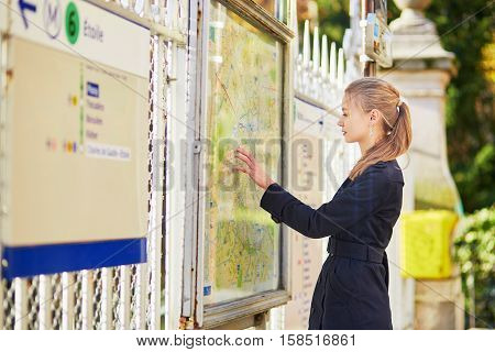 Parisian Woman Near The Subway Plan, Looking For The Direction