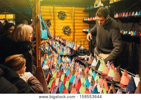 STRASBOURG FRANCE - NOV 28 2015: Traditional Christmas Market in Strasbourg Alsace France with people buying textile souvenirs