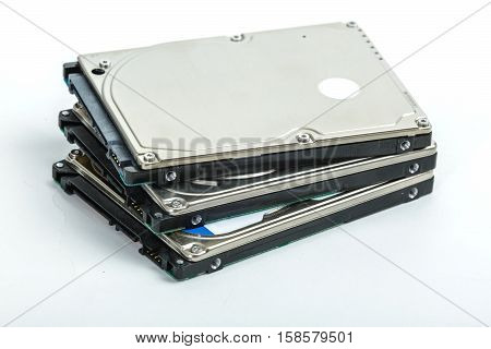 Three 2.5 inch laptop hard disk drives lie on each other. Isolated on white background.