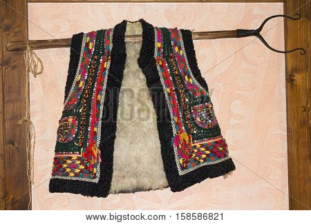 Traditional hutsul sheepskin vest hanging on the wall. Ukraine