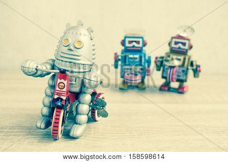 Old robot toy on wood table, vintage color style, vintage tone background.