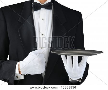 Closeup of a tuxedo wearing waiter holding a silver tray in front of his body. Horizontal format on white.