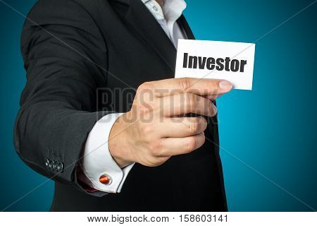 Businessman with investor card on chest in black suit