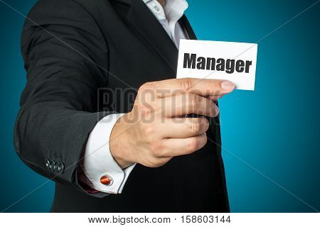 Businessman with manager card on chest in black suit