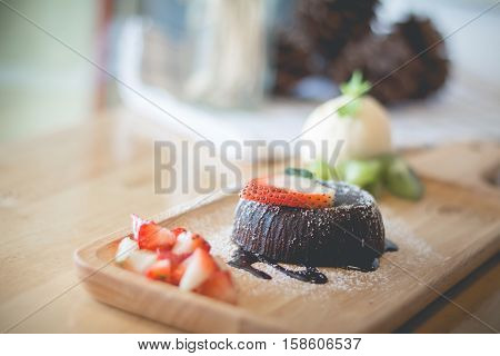 Chocolate lava cake with vanilla ice cream and strawberry. Chocolate lava. Hot chocolate pudding with fondant centre.(selective focus)