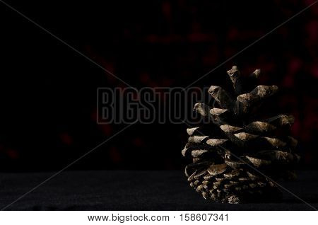 Christmas Pine Cone On A Dark Red Background