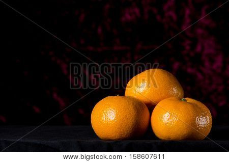 Christmas Tangerine Or Mandarin On A Dark Red Background