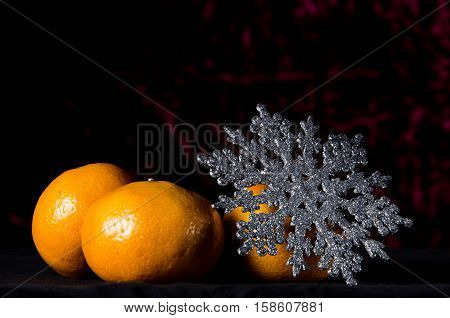 Christmas Tangerine Or Mandarin With New Year Star On A Dark Red Background