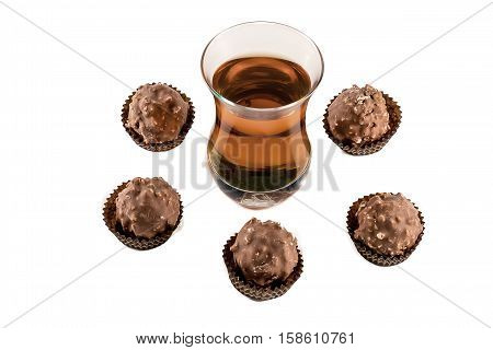 Glass with cognac and chocolate isolated on white background