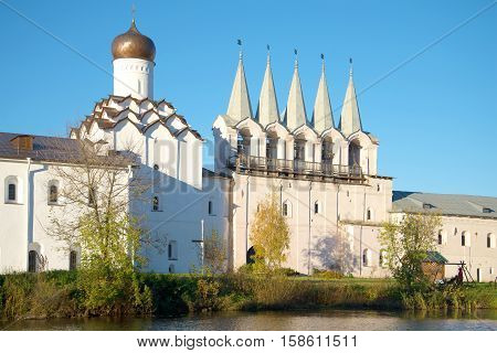 View of a belfry of the old Tikhvin Uspensky monastery in the October evening. Tikhvin, Russia