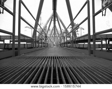 Bridge platform connected between wellhead platform and central processing platform that is route of support of oil and gas piping from remote to central processing platform underneath bridge