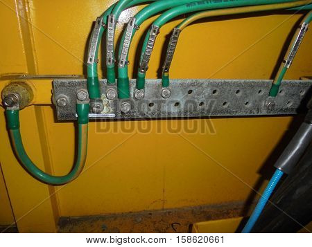 Electrical ground wires connected to a metal junction plate.