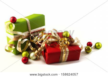 Wrapped presents with red and green paper golden ribbons and christmas balls for the holidays isolated on a white background