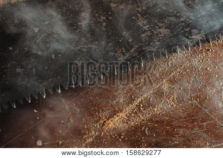 a hacksaw on the old table background texture lies