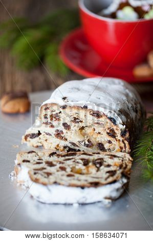 Christmas stollen. Traditional German, European festive dessert. Ingredients cranberries, pine nuts for Christmas Stollen. Stollen cake cut into pieces. Christmas food card.