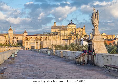 Sculprure depicting St. Raphael in the middle of Roman bridge of Cordoba Andalusia Spain