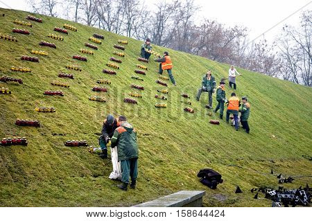 Kyiv Ukraine - December 02 2007: Workers put candles near the memorial to the victims of Holodomor 1932 -1933. Ukrainian nation commemorates the victims of famines (Holodomors) and political repression