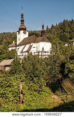 Fortified church in Spania Dolina Slovak republic. Travel destination. Religious architecture. Beautiful place. Yellow photo filter. Vertical composition.