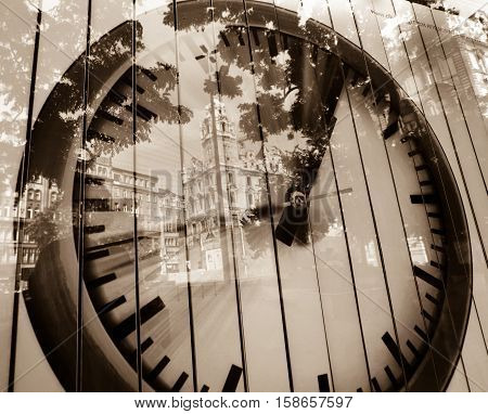 Analog clock advertisement with the reflection of Budapest city.
