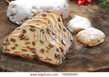 Christmas stollen with Christmas decoration on a wooden plate