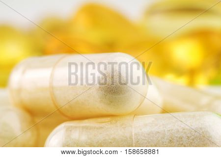 Natural food supplement pills glucosamine and omega 3 capsules macro image
