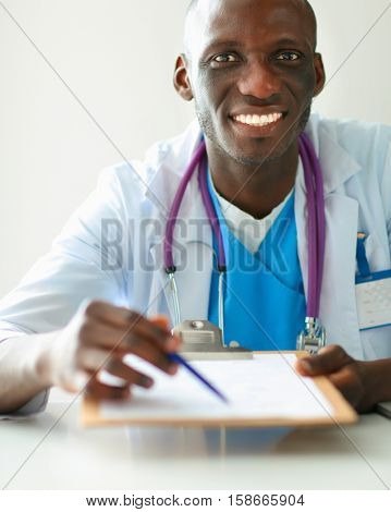 Male doctor sitting at his desk