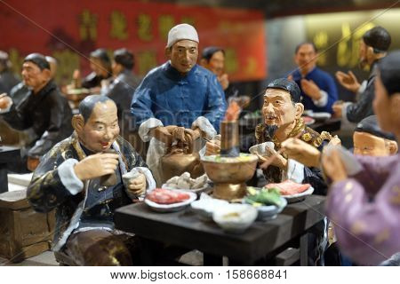 BEIJING - FEBRUARY 24: Chinese figures in restaurant at famous Qianmen pedestrian commercial street in Beijing, China, February 24, 2016.