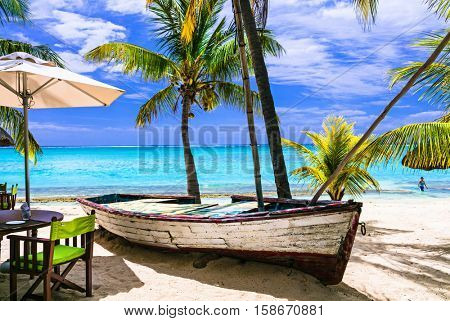 amazing tropical holidays. Beach restaurant with old boat. Mauritius island
