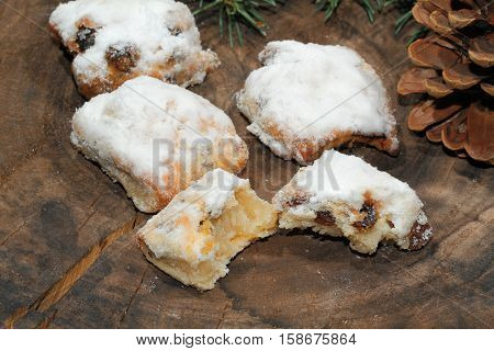 Christmas stollen with Christmas decoration on a wooden plate