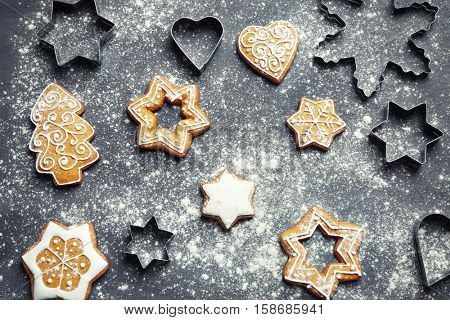 Delicious Christmas cookies with scattered powdered sugar on gray background