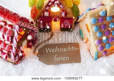 Label With German Text Frohe Weihnachten Means Merry Christmas. Colorful Gingerbread House On Snow And Snowflakes. Christmas Card For Seasons Greetings