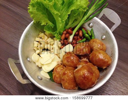 Isaan sausage, Thai Northeastern sausage, Thai pork mix rice sausage served in dish on wooden table background