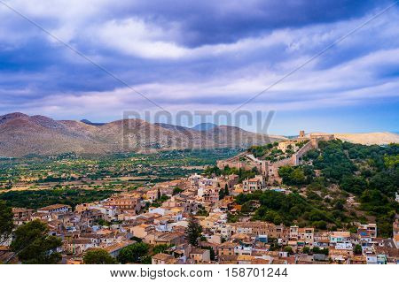 Capdepera castle on green hill in Mallorca island, Spain.
