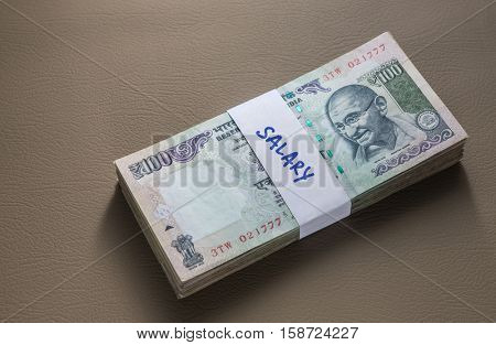 Employees salaries in cash. Rs hundred notes sealed with paper band.
