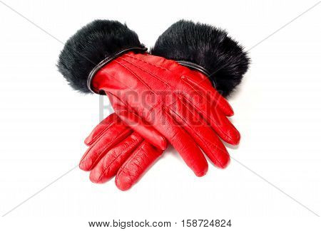 Closeup of women red winter leather gloves with natural black rabbit fur isolated on white background.
