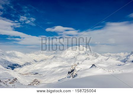 Alpine winter mountain landscape. French Alps covered with snow in sunny day. Val-d'Isere, France