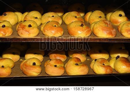 Home made Lucia bakery with raisin in oven.