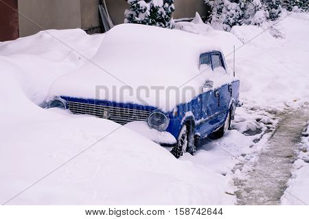blue car covered with snow winter seasons