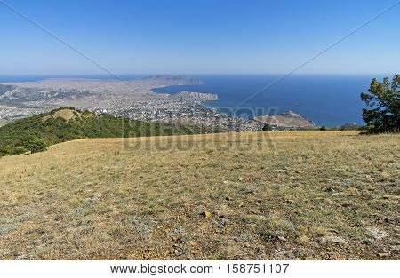 A view of the Crimean coast from the top of the mountain. The surroundings of the resort town of Sudak. September.