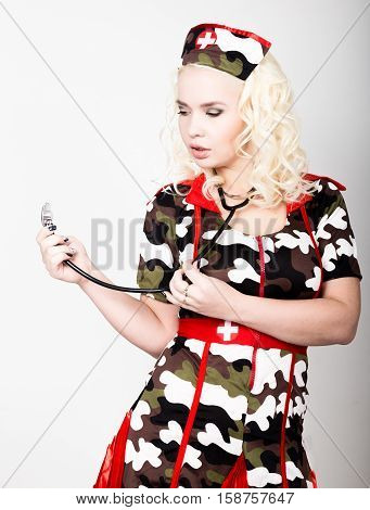 young beautiful woman dressed as a miliyary nurse, medical carnival costume.