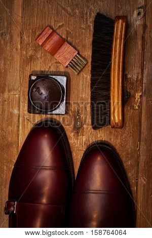 Still life with men's leather shoes and accessories for shoes care.