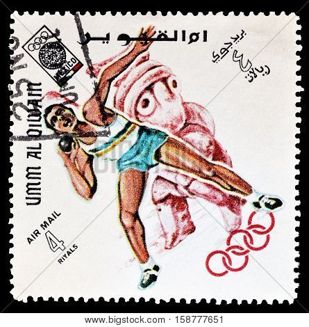 UMM AL QIWAIN - CIRCA 1968 : Cancelled postage stamp printed by Umm Al Qiwain, that shows Shot putting.