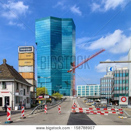 Zurich, Switzerland - 4 April, 2016: road works on Geroldstrasse street, Prime Tower building in the background. Zurich is the largest city in Switzerland and the capital of the Swiss canton of Zurich.