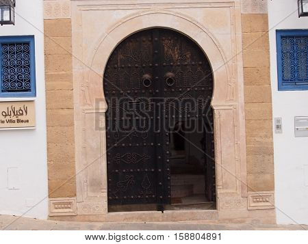 arch doorway with a metal shod door in the Moroccan style