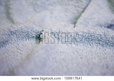 Closeup view of towel. Fluffy white background